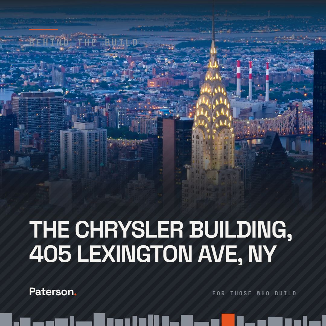 Behind the Build graphic: the Chrysler Building, 405 Lexington Avenue, its lit crown rising above the Midtown East skyline at dusk